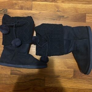 Black boots with pom poms.